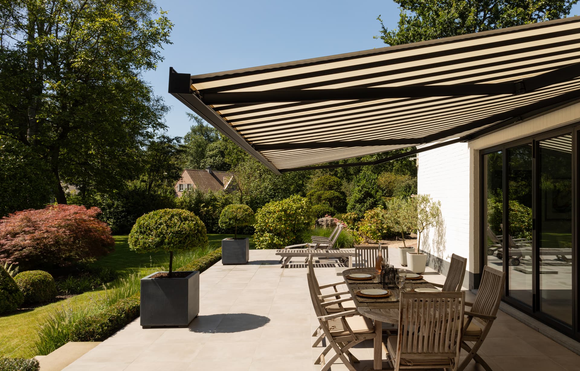 Black and white striped awning open on a summer day